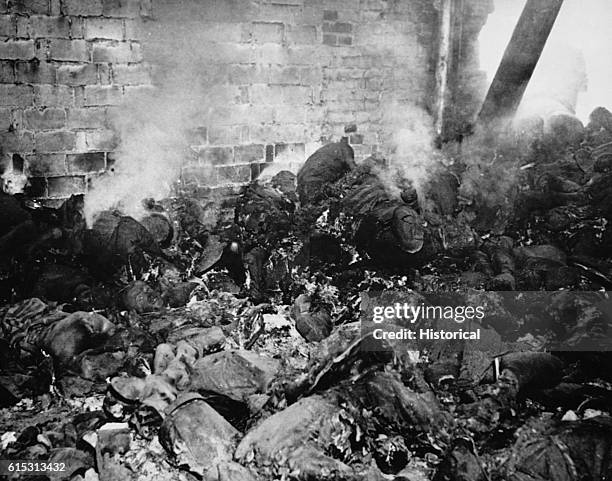 The still smoldering bodies of victims driven into a gasoline-soaked barn and incinerated by retreating SS.