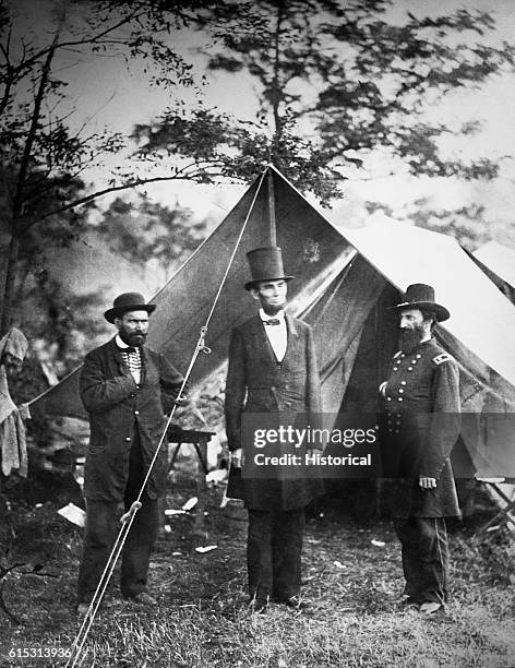 President Abraham Lincoln meets with Major Allan Pinkerton and General John A. McCleland at the Union camp on the battlefield at Antietam Creek,...