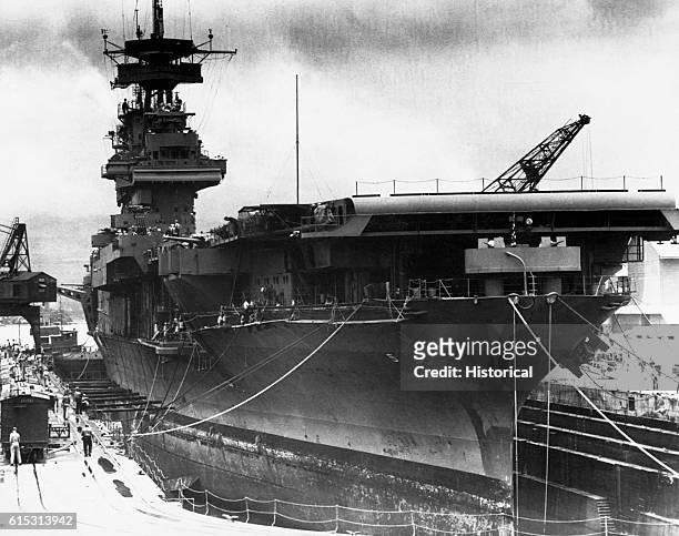 The aircraft carrier USS Yorktown is in dry dock at Pearl Harbor, being readied for the Battle of Midway. June 1942.