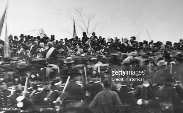 Crowd listens to President Abraham Lincoln giving his famous Gettysburg Address, a speech given at the dedication of the Civil War cemetery in...