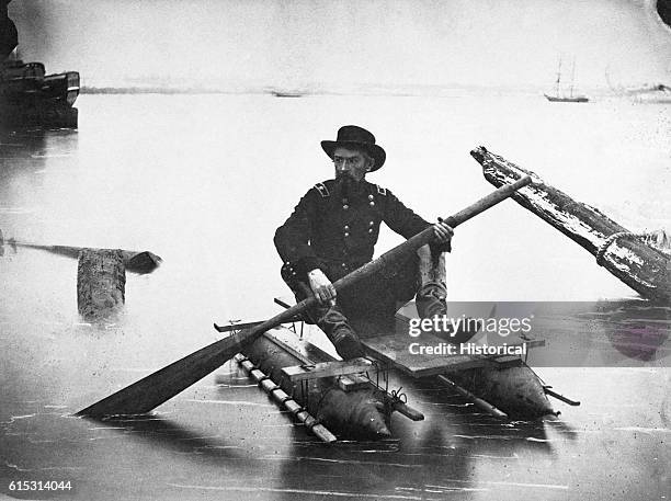 Soldier in the Union Army paddles a pontoon boat, designed to facilitate scouting operations, ca. 1863.