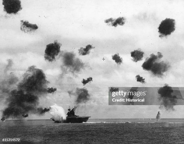 The American aircraft carrier USS Yorktown takes a hit while being bombed in the Battle of Midway, June 1942.