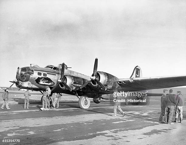 Ground crew members attend to a B-17 Flying Fortress of U.S. Army Bombing Squadron at Dunkswell, England. December 13, 1944. | Location: Dunkswell,...
