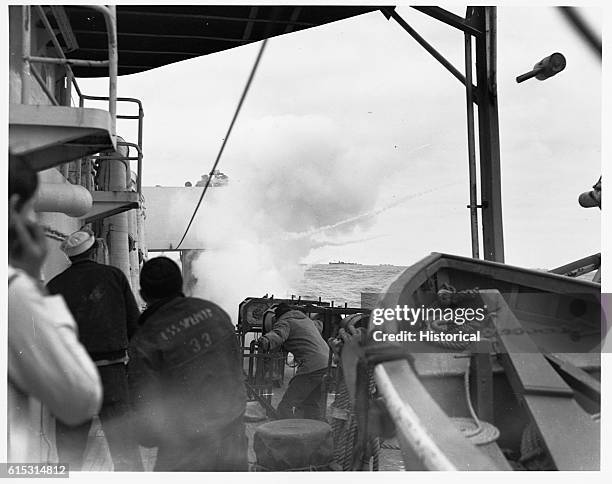 Gun is put into action on board the U.S. Coast Guard Cutter Spencer following detection of a submarine below surface. World War II.