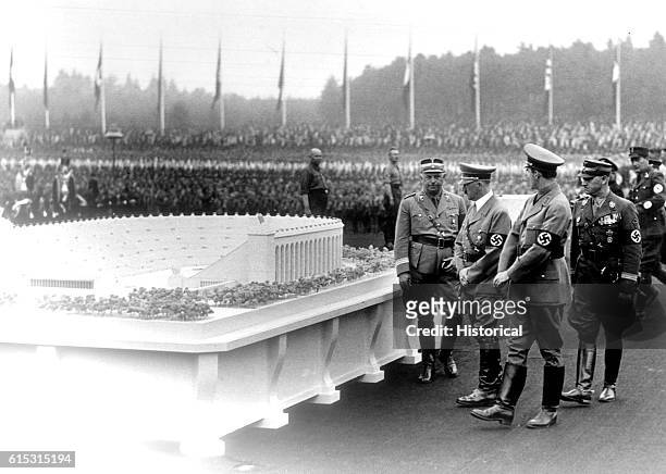 German Chancellor Adolf Hitler and architect Albert Speer inspect Speer's model for a huge stadium to be built at Nuremberg.
