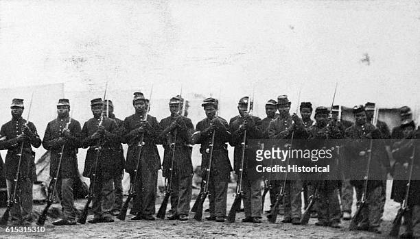 Members of an honor guard of black troops at Port Hudson, Louisiana hold rifles with bayonets attached. | Location: Port Hudson, Louisiana, USA.