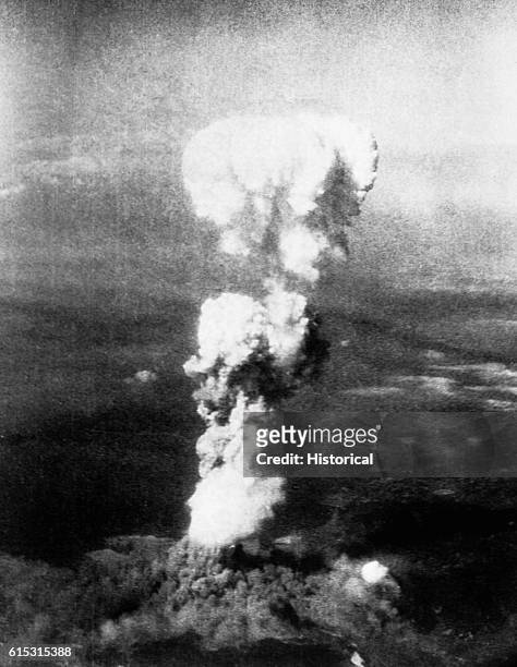 The mushroom cloud from the atomic bomb Little Boy, dropped by American B-29 Superfortress bomber Enola Gay, signals the doom of Hiroshima, Japan on...