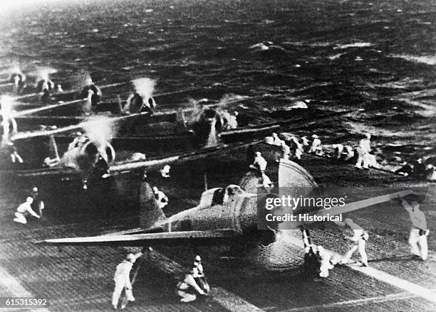 Japanese photograph shows Mitsubishi dive bombers warming up on the deck of a carrier in the Pacific before their attack on Pearl Harbor in the early...