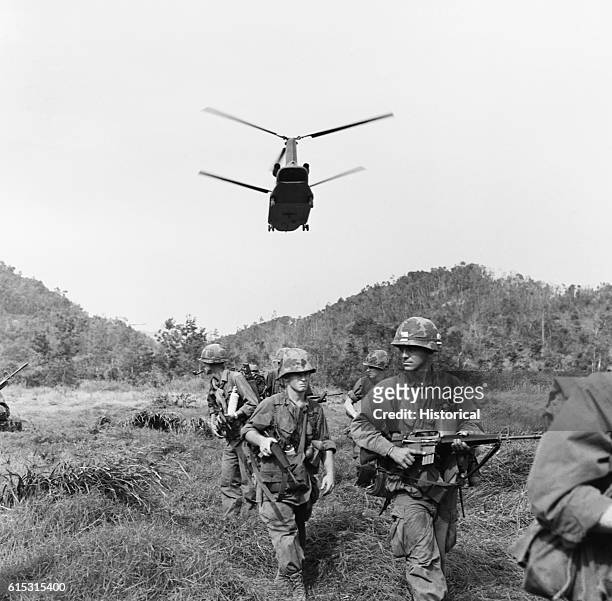 Helicopter brings in more troops to a combat area. Vietnam, 1967.