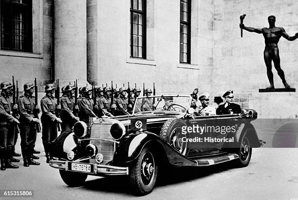 The Italian foreign minister, Count Galeazzo Ciano, after arriving in Berlin is accompanied by the German Counsel to meet with Hitler to discuss the...