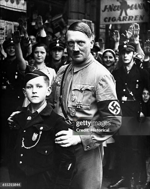 Nazi dictator Adolph Hitler poses with a young member of the Nazi Youth.