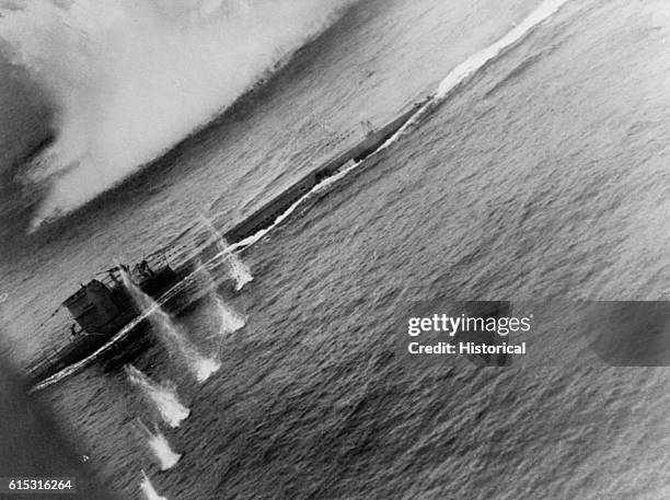 Series of small eruptions in the water show the path of an air attack on German Submarine U-134. John T. Hitchcock piloted the VP-201