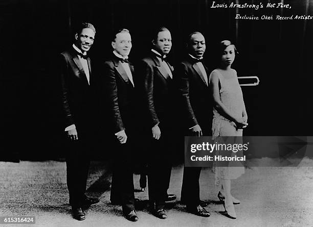 Louis "Satchmo" Armstrong and his "Hot Five" band, left to right: Johnny St. Cyr, Edward 'Kid' Ory, Louis Armstrong, Johnny Dodds, Lillian Armstrong.