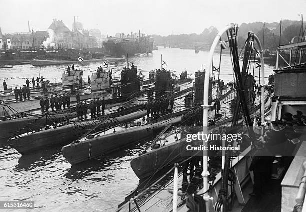 Line of submarines rest on the surface in a harbor at Kiel, Germany, October 2, 1918.