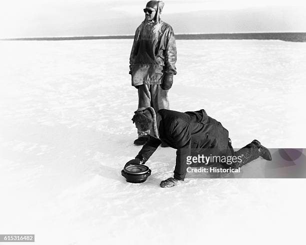 Admiral Byrd taking bearings with magnetic compass on Dry galski Ice Tongue.