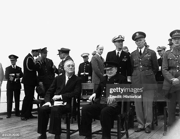 Franklin D. Roosevelt, Winston Churchill, Admiral Ernest King, General George Marshall, and others on the deck of the HMS Prince of Wales during the...