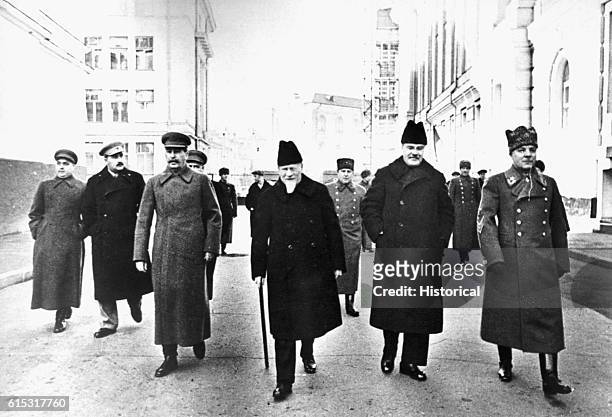 Group of Soviet leaders walk through the Kremlin on their way to review a parade and demonstration in Red Square. Left to right: Georgi Malenkov,...