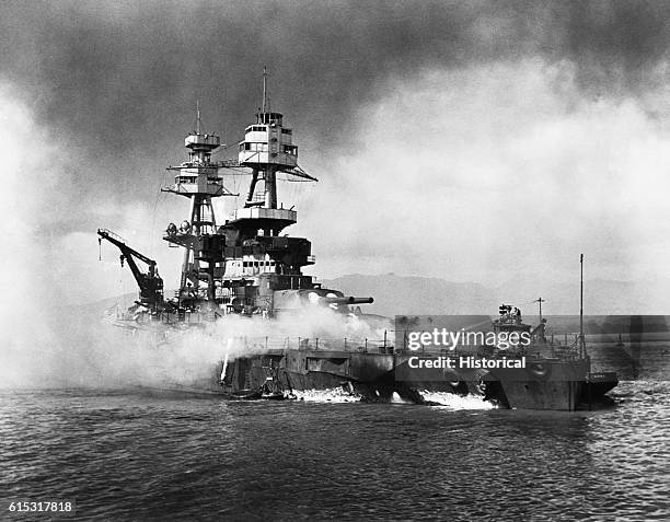 The USS Nevada burns following the surprise attack on Pearl Harbor by the Japanese military.