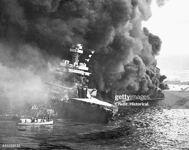 Crew members from the USS California abandon their burning ship after the Japanese attack on Pearl Harbor. December 7, 1941.
