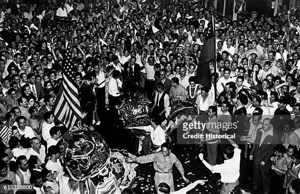 Crowds cheer wildly in New York City's China Town after they heard the announcement of Japan's unconditional surrender, August 15, 1945. | Location:...