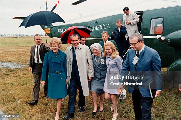 President Richard Nixon, his wife Pat and daughter Tricia arrive on a rainy day to witness the Apollo 12 moon shot in 1969.