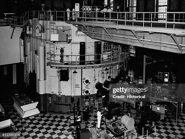 Scientists stand on rubber tiled floor while they assemble experimental equipment at the restored NRX reactor at Chalk River, Ontario, Canada. Ca....