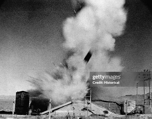 Portions of a nuclear reactor tank, control rod mechanism, and core have been hurled into the air by the force of an explosion caused by scientists...