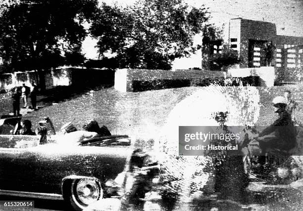 The motorcade drives on after John F. Kennedy is shot. November 22 Dallas, Texas.