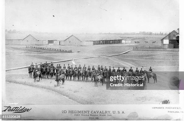 Second Regiment Cavalry sit on horses in front of the stables at Fort Walla Walla. July 1886, Washington Territory. Second Regiment Cavalry sit on horses in front of the stables at Fort Walla Walla. July 1886, Washington Territory.