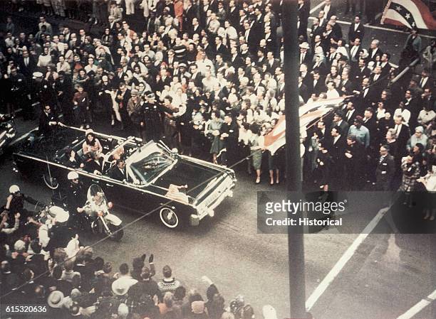 President John F Kennedy, First Lady Jacqueline Kennedy, and Texas Governor John Connally ride through the streets of Dallas, Texas prior to the...