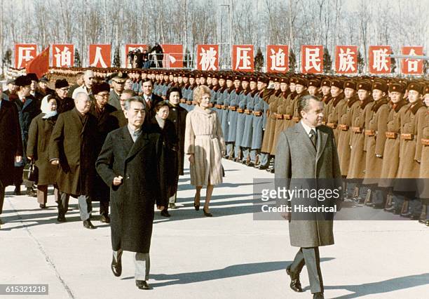 Before his departure, American President Richard Nixon inspects assembled Chinese soldiers with Chinese Premier Zhou Enlai, February 26, 1972.