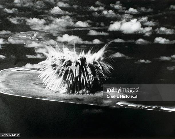 Fallout from a nuclear explosion rains back down on Bogon Island after the "Seminole" explosion of Operation REDWING on Enewetak Atoll in the Pacific...