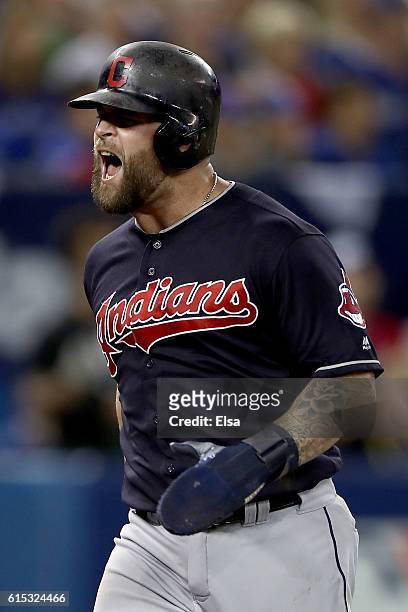 Mike Napoli of the Cleveland Indians celebrates after scoring a run off of a single hit by Jose Ramirez in the sixth inning against Joe Biagini of...