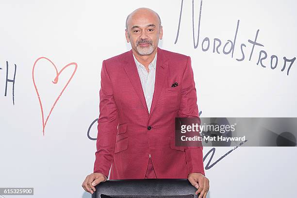 Fashion designer Christian Louboutin poses for a photo during a personal appearance at Nordstrom Downton Seattle on October 17, 2016 in Seattle,...