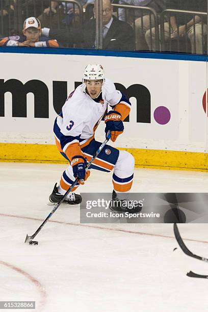 New York Islanders Denfenseman Travis Hamonic with the puck during the first period of opening night at Madison Square Garden in a NHL game between...