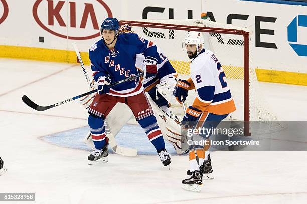 New York Rangers Right Wing Jesper Fast screens New York Islanders Goalie Jaroslav Halak during the first period of opening night at Madison Square...