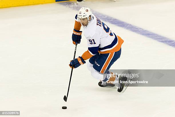 New York Islanders Center John Tavares with the puck during the first period of opening night at Madison Square Garden in a NHL game between the New...