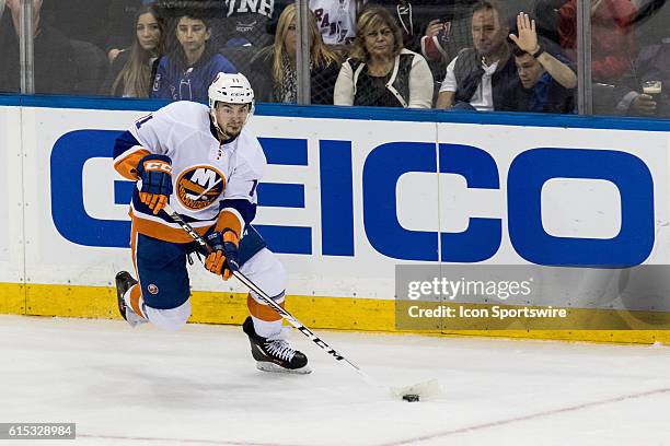 New York Islanders Center Shane Prince with the puck behind the Islanders net during the first period of opening night at Madison Square Garden in a...