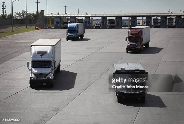 Trucks, including an armored car, pass through U.S. Customs on October 17, 2016 in Laredo, Texas. South Texas customs agents processed $166 billion...