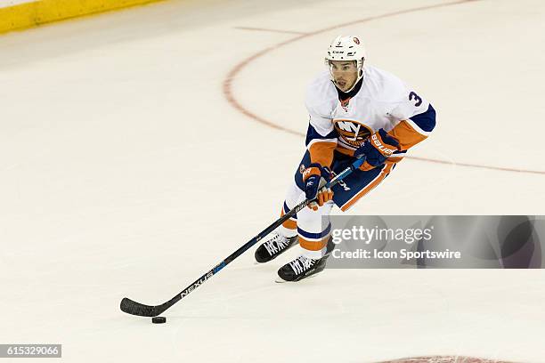 New York Islanders Denfenseman Travis Hamonic with the puck during the first period of opening night at Madison Square Garden in a NHL game between...