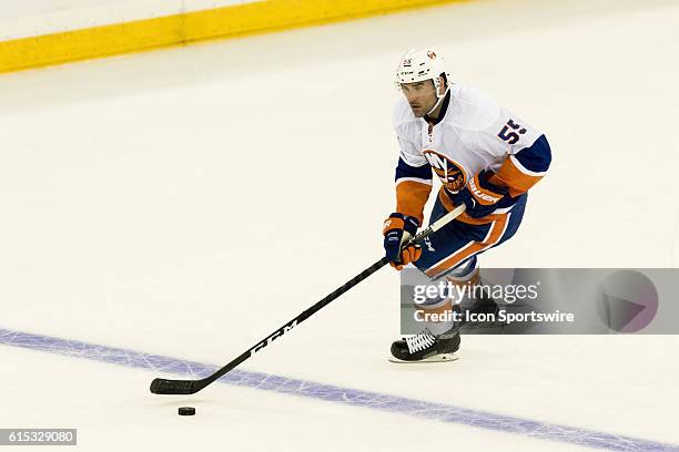 New York Islanders Denfenseman Johnny Boychuk with the puck during the first period of opening night at Madison Square Garden in a NHL game between...