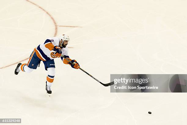 New York Islanders Denfenseman Nick Leddy centers the puck during the second period of opening night at Madison Square Garden in a NHL game between...