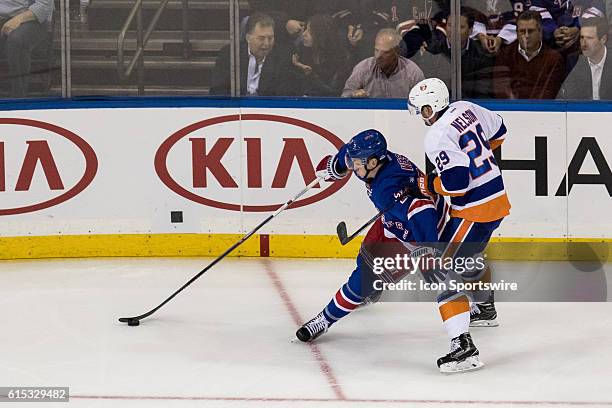 New York Rangers Left Wing Jimmy Vesey controls the puck behind the Islanders goal line during the second period of opening night at Madison Square...
