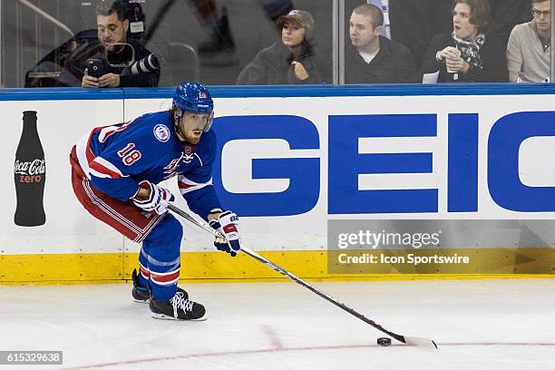 New York Rangers Defenseman Marc Staal with the puck in the Islanders zone during the third period of opening night at Madison Square Garden in a NHL...