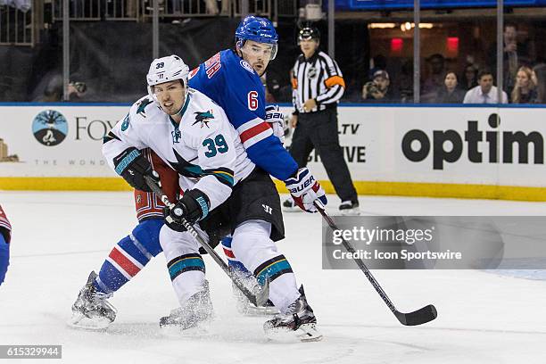 New York Rangers Defenseman Dylan McIlrath reaches around San Jose Sharks Center Logan Couture during the first period of a NHL game between the San...