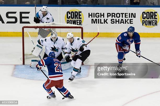 New York Rangers Center Derek Stepan losses a rebound between his legs in front of the Sharks net during the second period of a NHL game between the...
