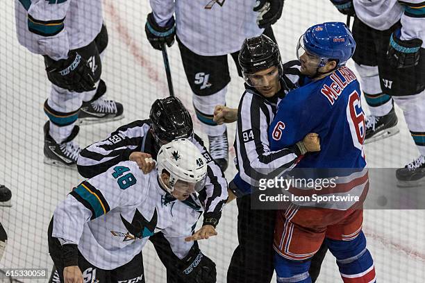 Referees separate New York Rangers Defenseman Dylan McIlrath and San Jose Sharks Center Tomas Hertl during the second period of a NHL game between...