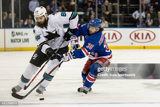 New York Rangers Right Wing Mats Zuccarello reaches in on San Jose Sharks Defenseman Brent Burns during the third period of a NHL game between the...