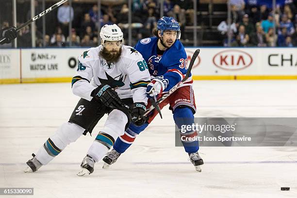 New York Rangers Right Wing Mats Zuccarello tries to keep San Jose Sharks Defenseman Brent Burns clear of the puck during the third period of a NHL...