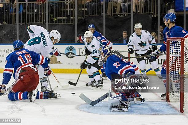 New York Rangers Defenseman Marc Staal gets a stick in front of San Jose Sharks Center Joe Pavelski in front of the net during the third period of a...